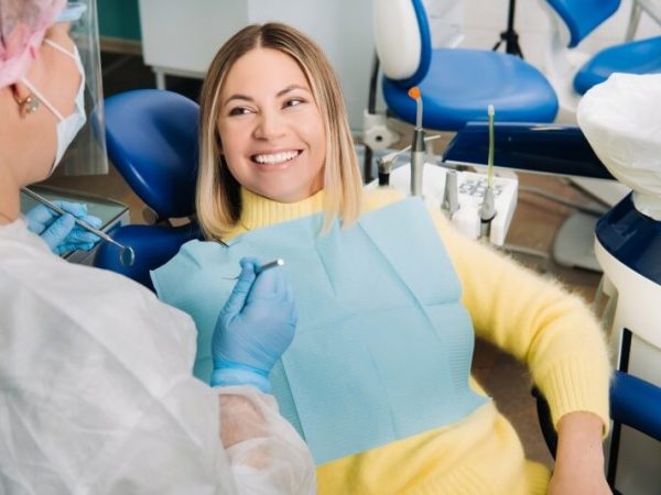 the-girl-smiles-at-the-dentist-and-looks-at-her-7WTGU43